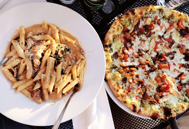 pizza and pasta on table